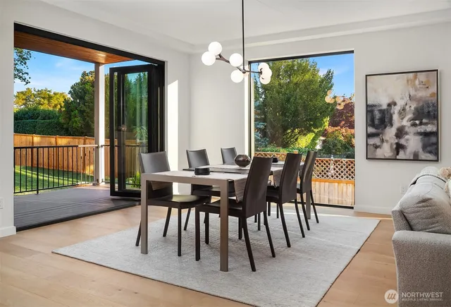 a dining room with furniture and a floor to ceiling window