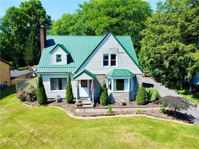 a front view of house with yard and green space