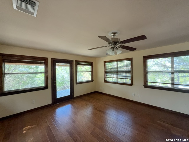 15005 Broken Bow Trail Austin, TX 78734 - Photo 7 of 13 a view of an empty room with wooden floor and a window