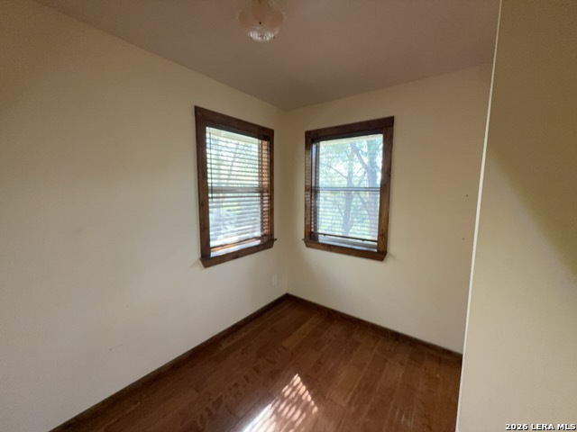 15005 Broken Bow Trail Austin, TX 78734 - Photo 10 of 13 a view of an empty room with wooden floor and a window