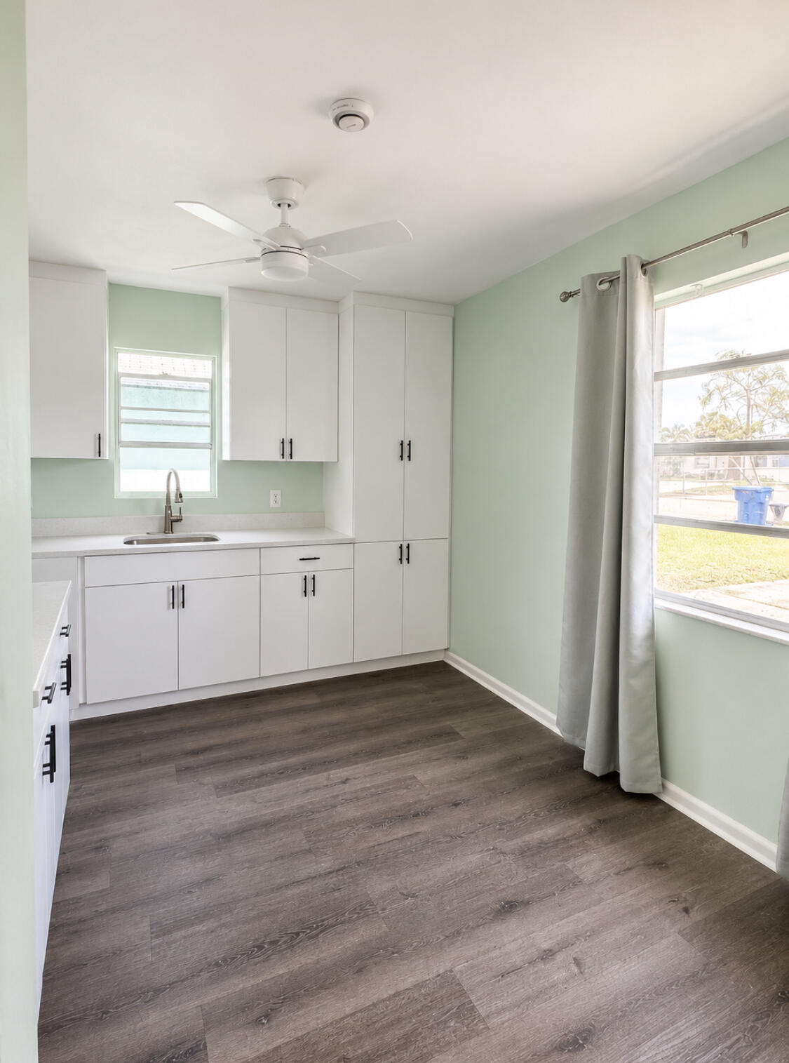 1328 West 6th Street Riviera Beach, FL 33404 - Photo 2 of 11 a view of a kitchen with wooden floor