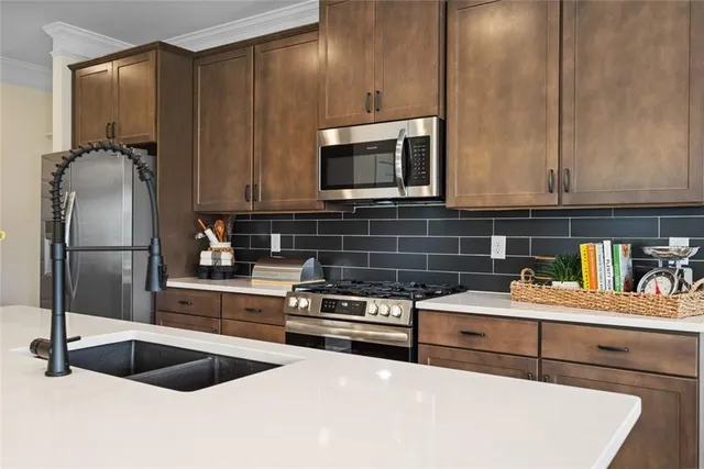 a kitchen with granite countertop a stove and a microwave