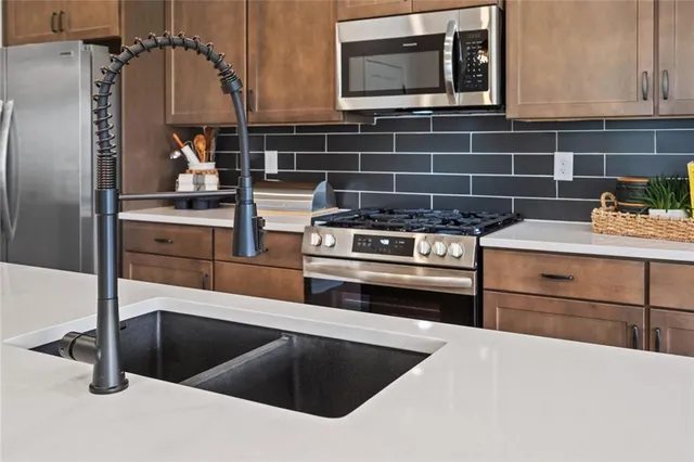 a large kitchen with a table and chairs