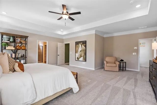 a living room with a bed and ceiling fan