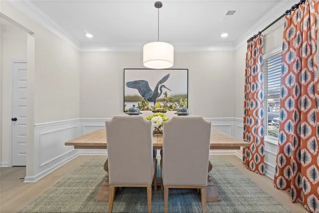a dining room with furniture and wooden floor