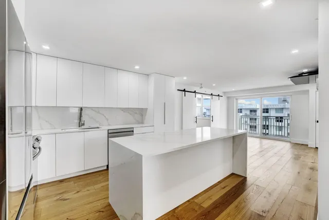 a kitchen with stainless steel appliances granite countertop a sink and cabinets