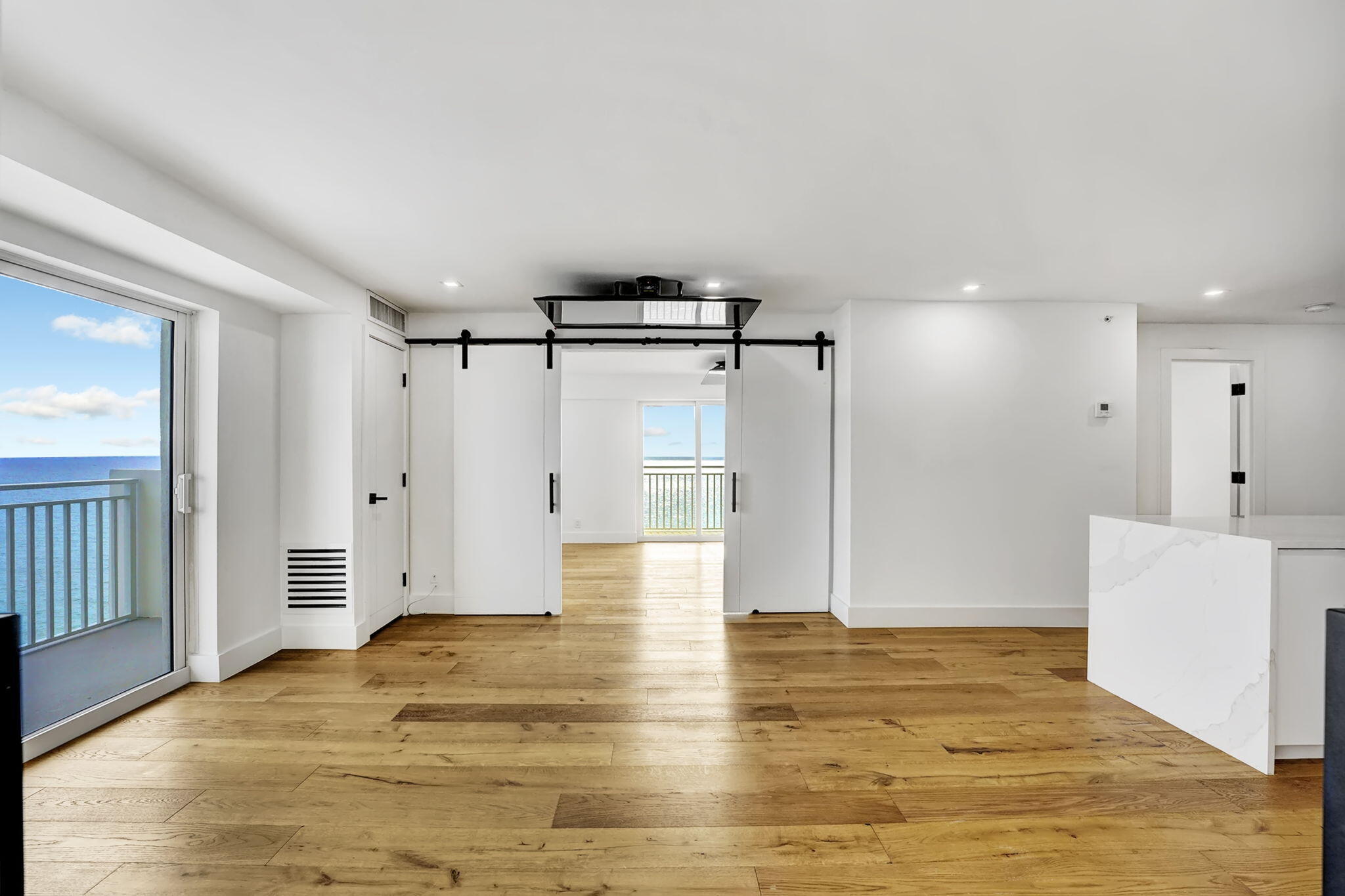 4511 South Ocean Boulevard, Unit 1008 Highland Beach, FL 33487 - Photo 11 of 32 a view of empty room with wooden floor and window