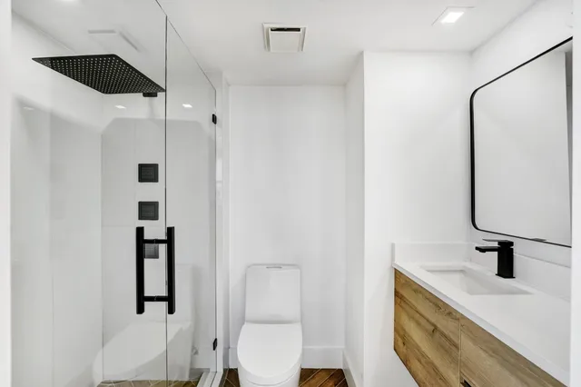 a bathroom with a sink toilet and shower