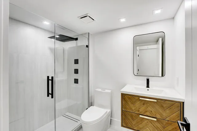a bathroom with a toilet sink shower