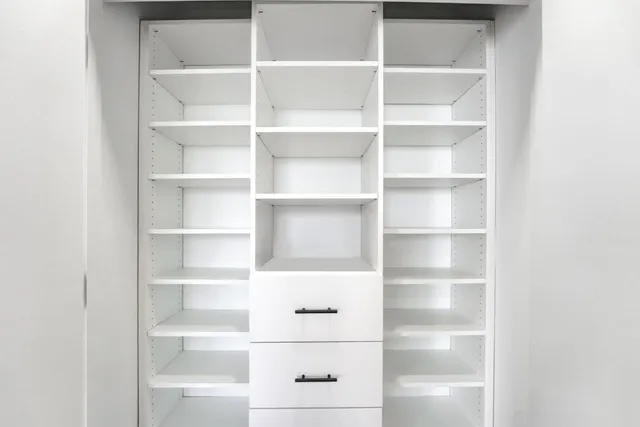 a view of a walk in closet with empty racks