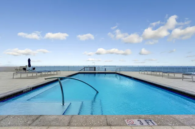 a view of a swimming pool and an outdoor seating
