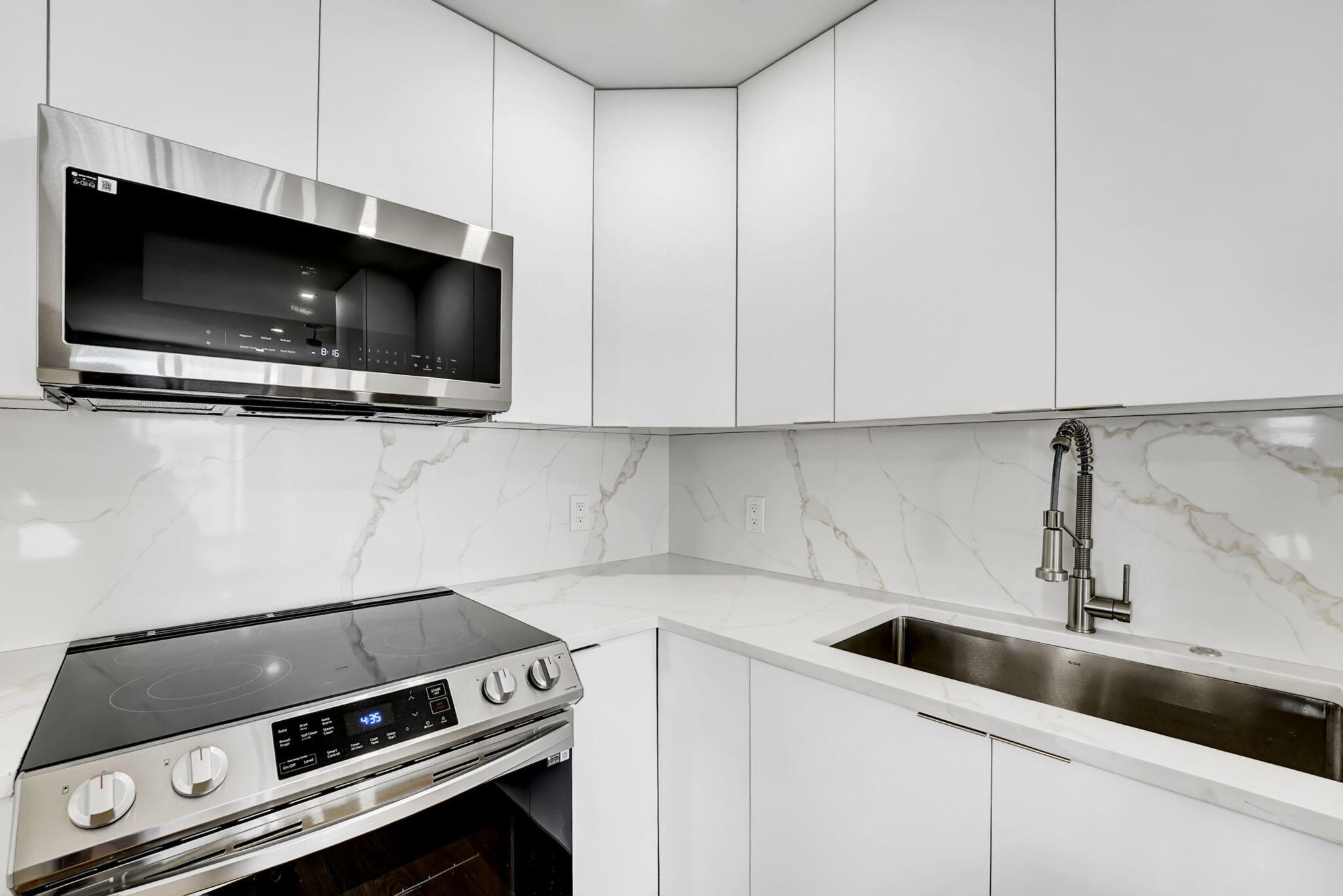 4511 South Ocean Boulevard, Unit 1008 Highland Beach, FL 33487 - Photo 4 of 32 a kitchen with a stove and a microwave