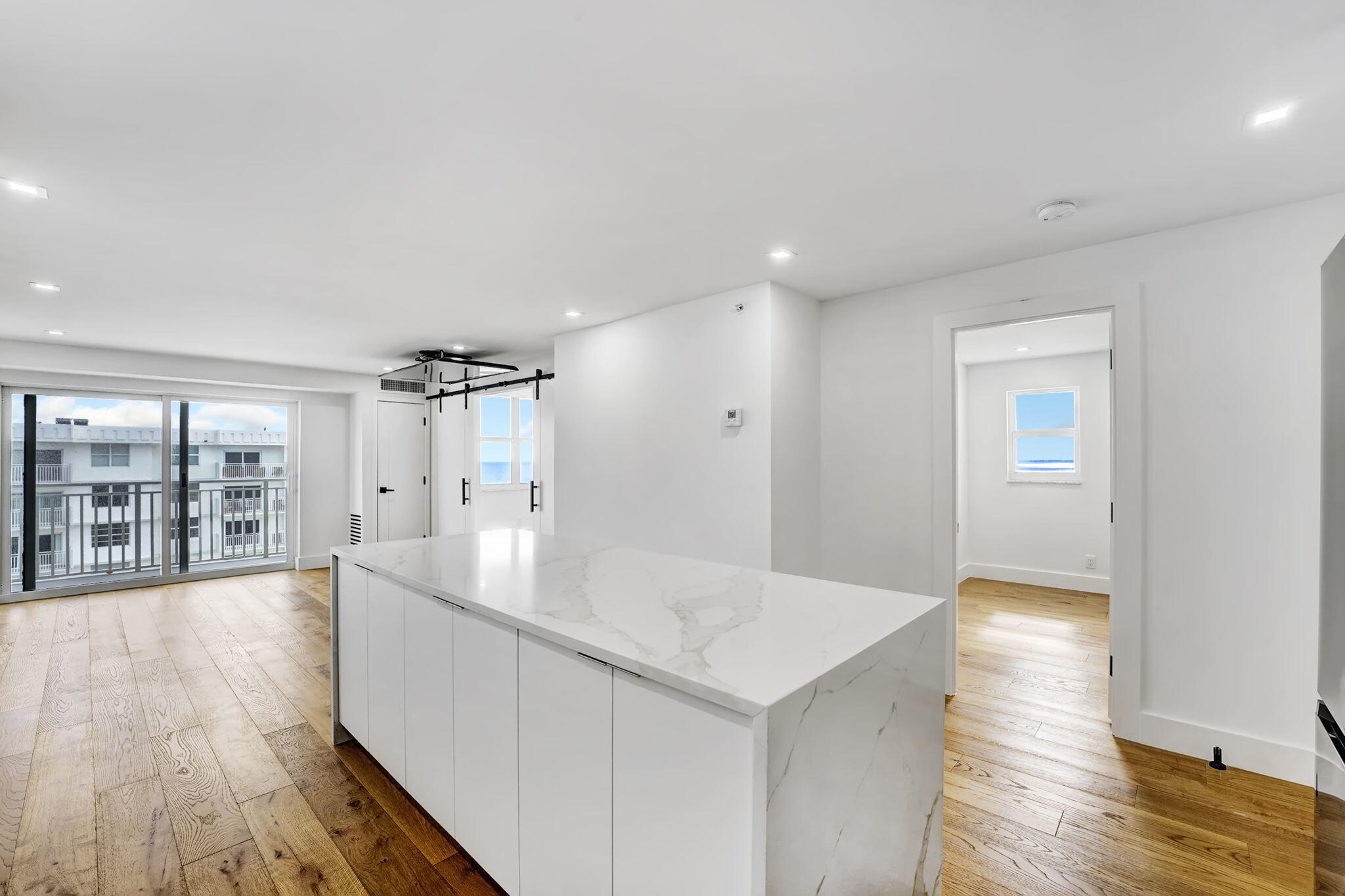 4511 South Ocean Boulevard, Unit 1008 Highland Beach, FL 33487 - Photo 5 of 32 a view of a big room with wooden floor and windows