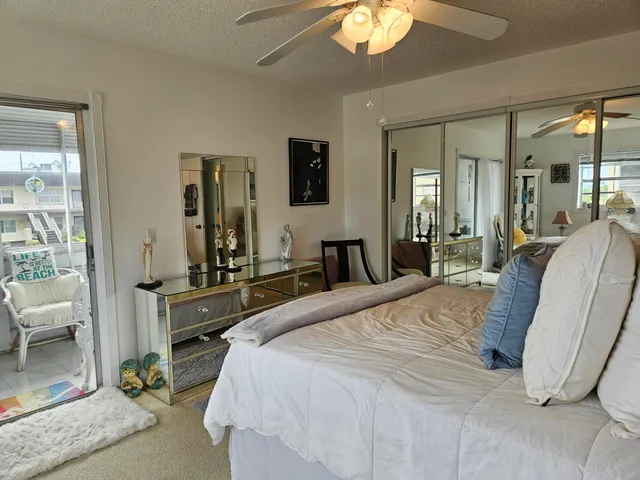 a spacious bedroom with a bed a table and chair