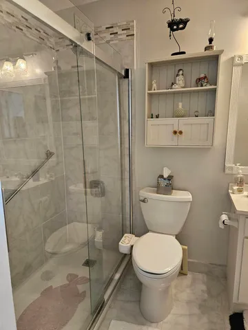 a bathroom with a toilet and a shower