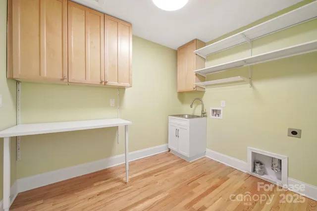 a room with a wooden floor and cabinets
