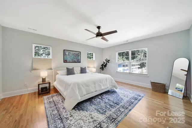 a spacious bedroom with a large bed and a window