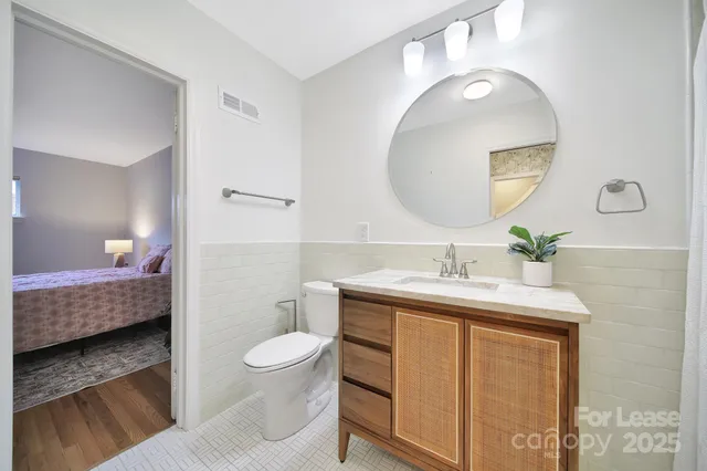 a en suite bathroom with a toilet sink and mirror