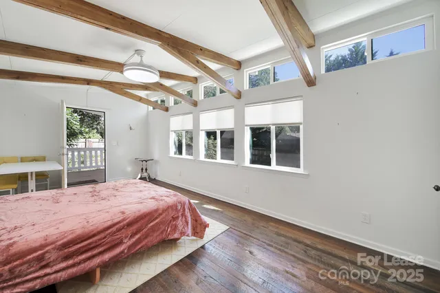 a bedroom with a large bed and a window