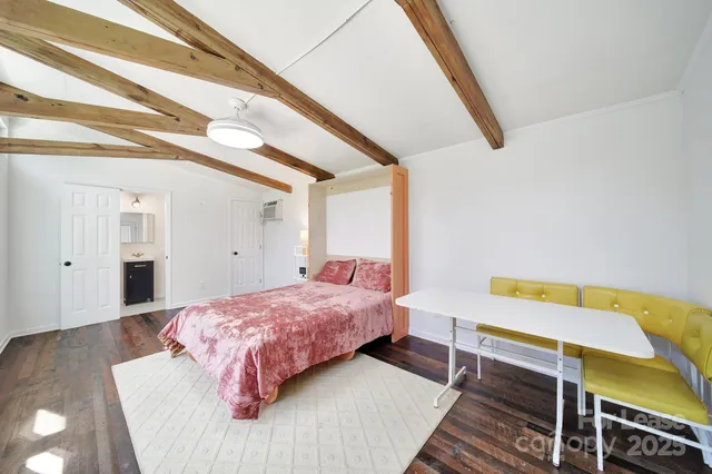 a bedroom with a bed and a table