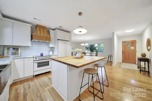 a kitchen with granite countertop stainless steel appliances and wooden cabinets