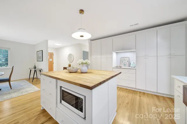 a kitchen with a stove and a wooden floors