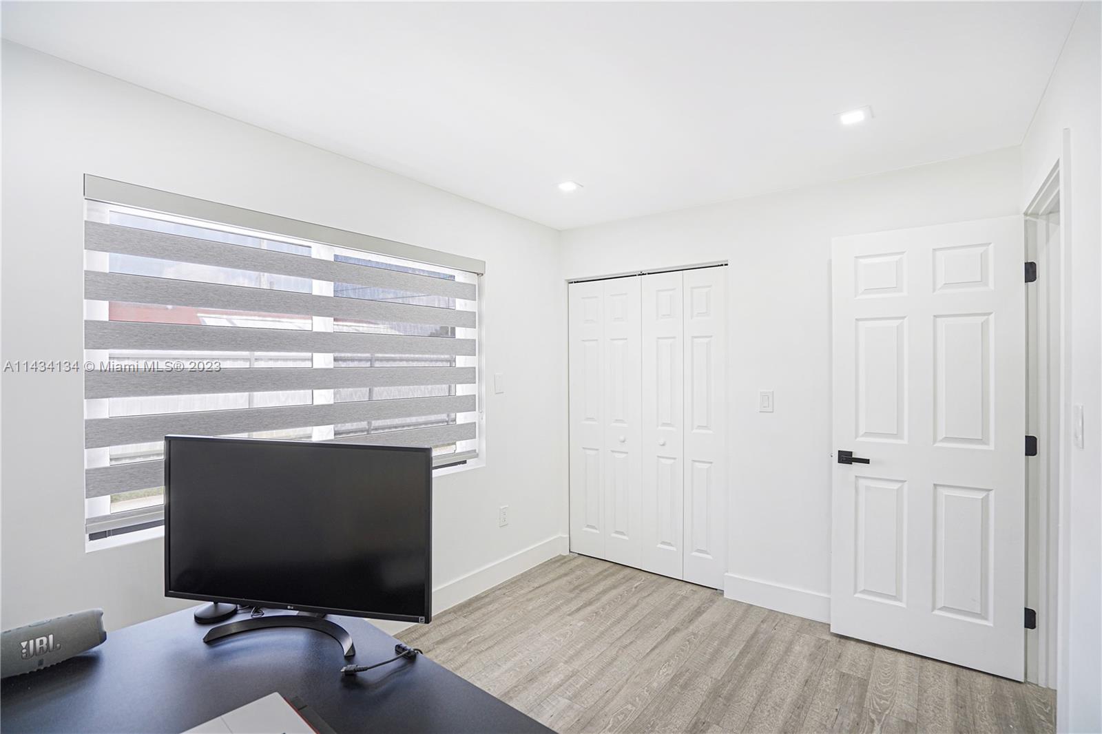 690 Southeast 3rd Place Hialeah, FL 33010 - Photo 23 of 31 a living room with a flat screen tv and a fireplace