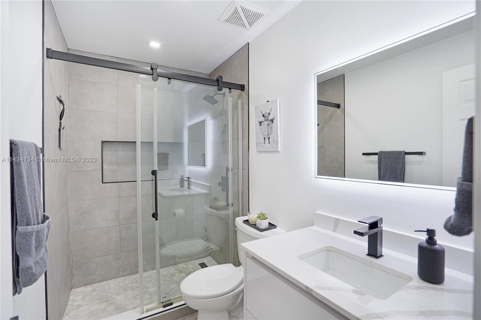 690 Southeast 3rd Place Hialeah, FL 33010 - Photo 5 of 31 a bathroom with a sink toilet and shower