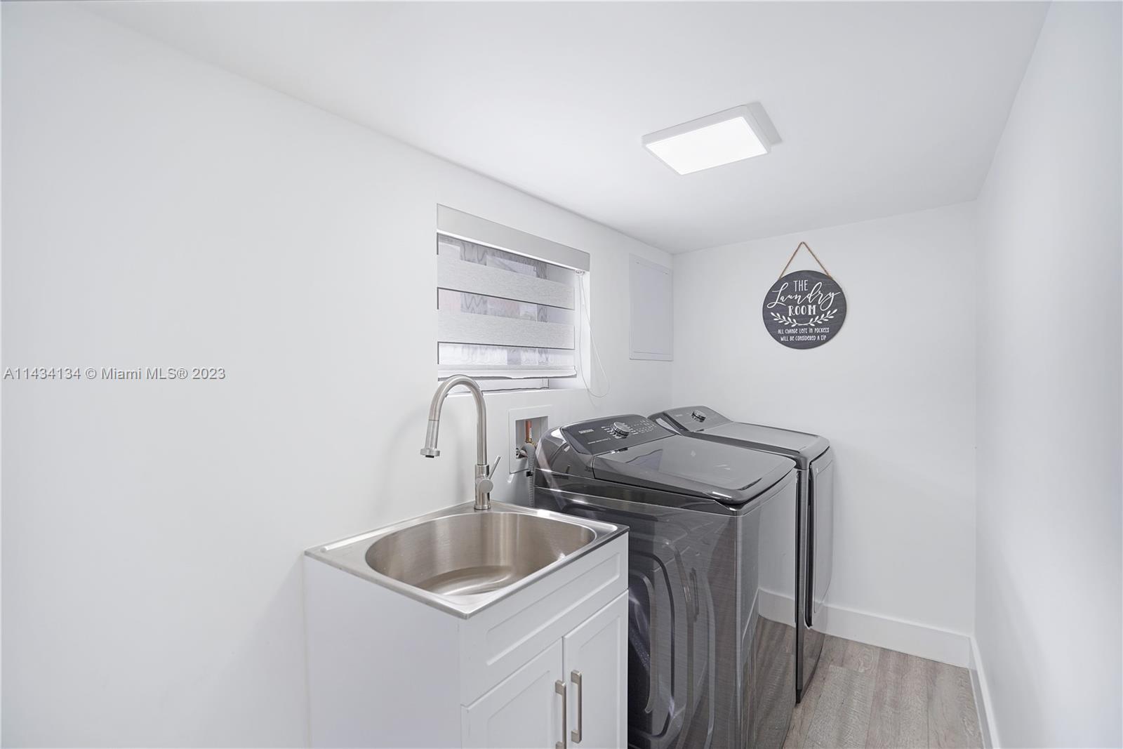 690 Southeast 3rd Place Hialeah, FL 33010 - Photo 8 of 31 a kitchen with a sink a stove and cabinets