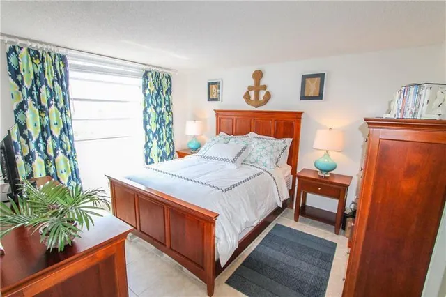 a bedroom with a bed and a potted plant