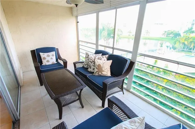 a living room with furniture and a floor to ceiling window