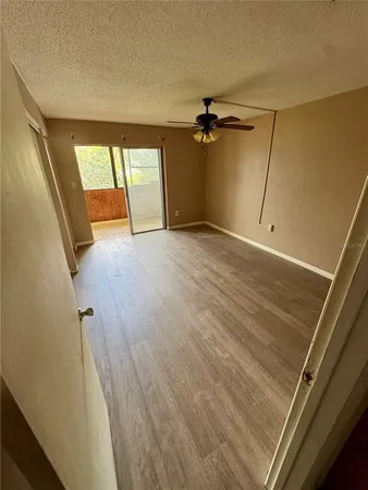 a view of a room with wooden floor and windows