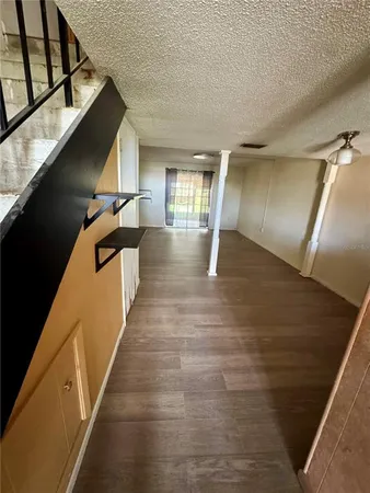 a view of entryway and hall with wooden floor