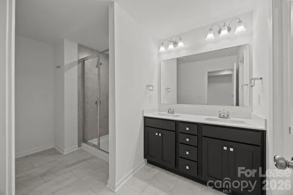 a bathroom with a glass shower door