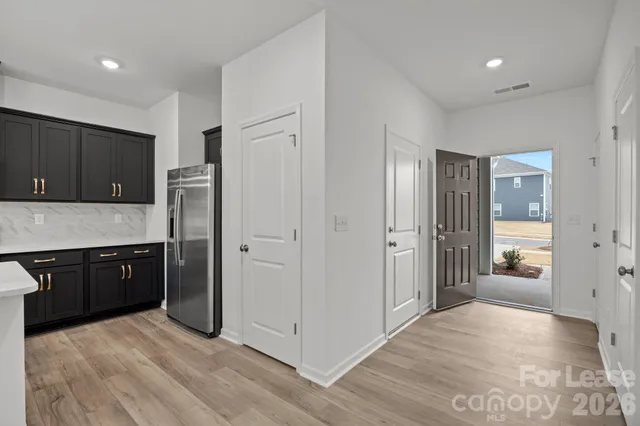 a kitchen with stainless steel appliances granite countertop a refrigerator and a stove top oven