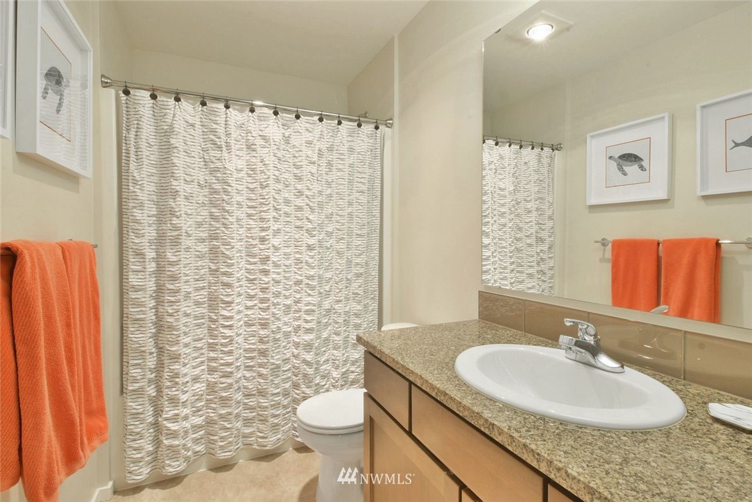 16517 2nd Park Southeast Bothell, WA 98012 - Photo 15 of 22 a bathroom with a granite countertop sink toilet and a mirror
