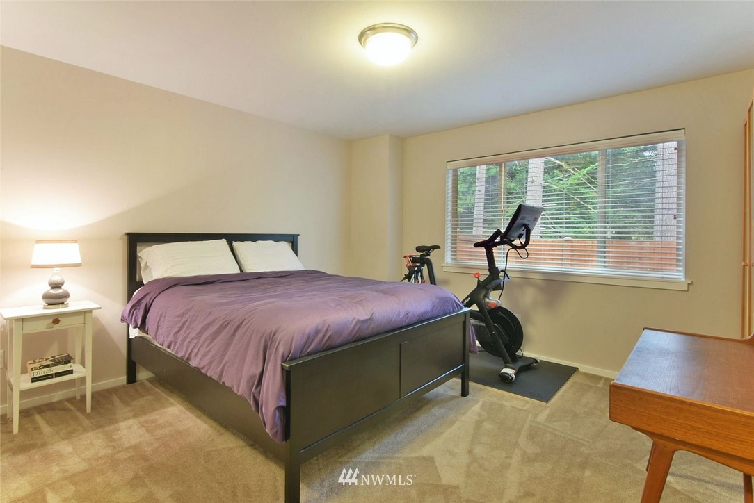 16517 2nd Park Southeast Bothell, WA 98012 - Photo 18 of 22 a spacious bedroom with a bed and a chair