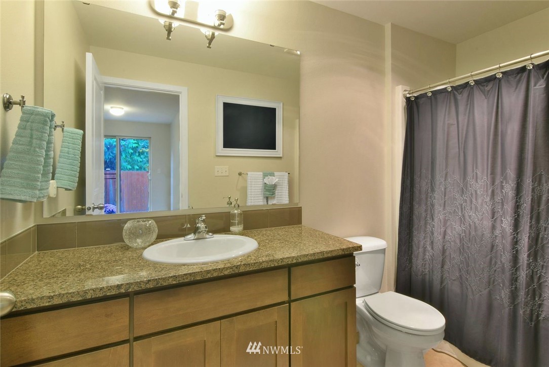 16517 2nd Park Southeast Bothell, WA 98012 - Photo 19 of 22 a bathroom with a granite countertop sink toilet and shower
