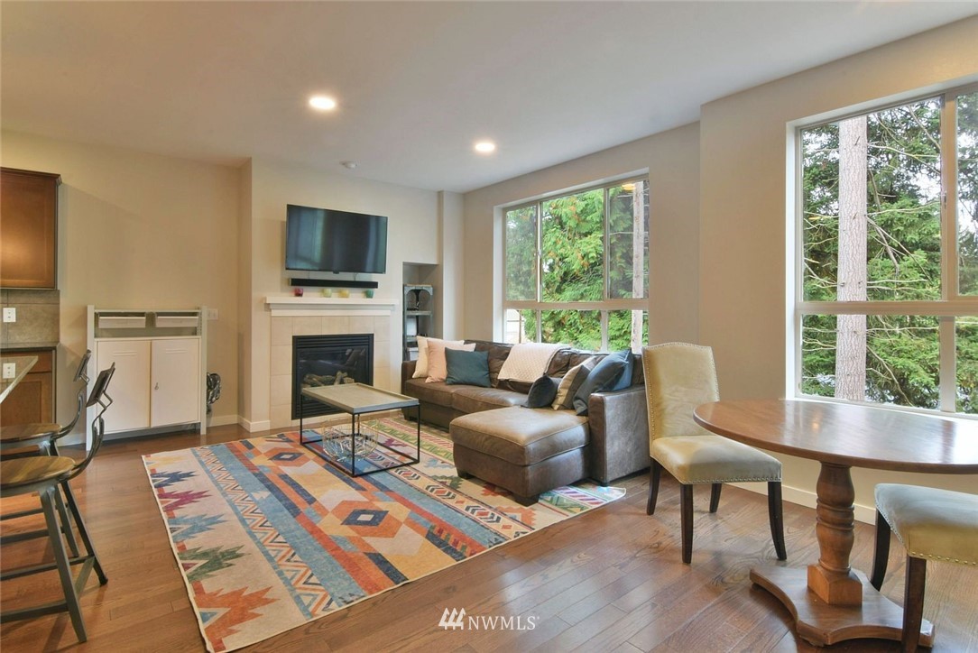 16517 2nd Park Southeast Bothell, WA 98012 - Photo 5 of 22 a living room with furniture a fireplace and a flat screen tv