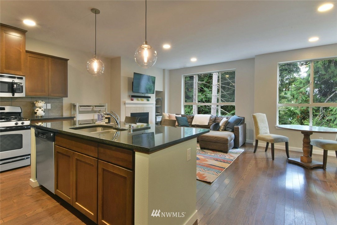 16517 2nd Park Southeast Bothell, WA 98012 - Photo 9 of 22 a kitchen with counter top space a sink appliances and living room view