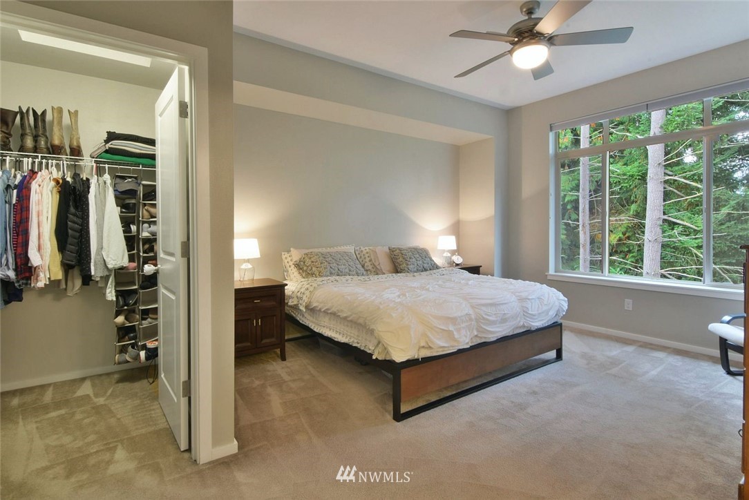 16517 2nd Park Southeast Bothell, WA 98012 - Photo 10 of 22 a bedroom with a bed and a chandelier