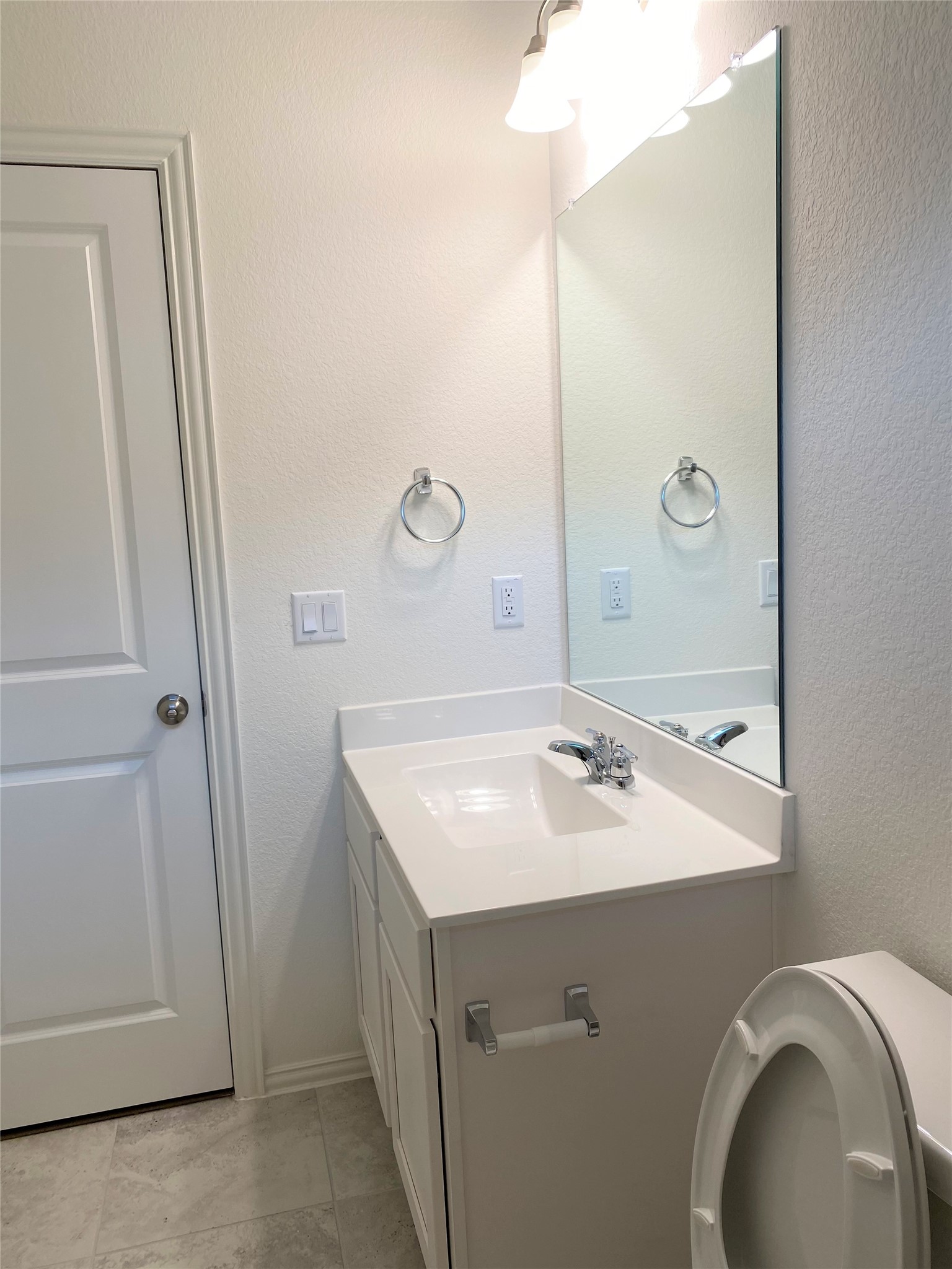 1309 Terrace View Georgetown, TX 78628 - Photo 27 of 36 A well-appointed bathroom features a single vanity, a modern toilet, and a large mirror for daily routines.