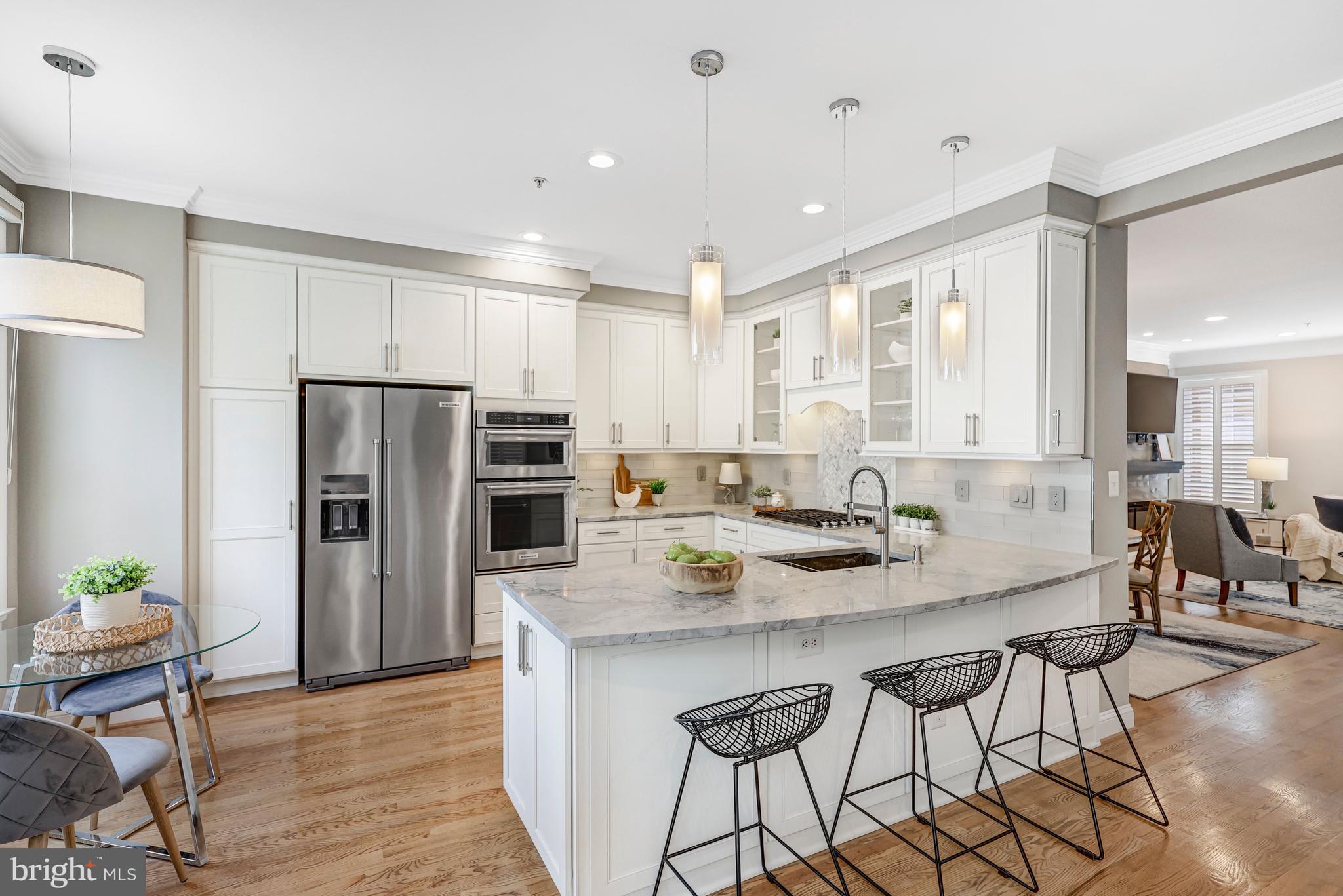 17 Alexander Street Alexandria, VA 22314 - Photo 11 of 30 a kitchen with granite countertop a center island stainless steel appliances cabinets and a counter top space