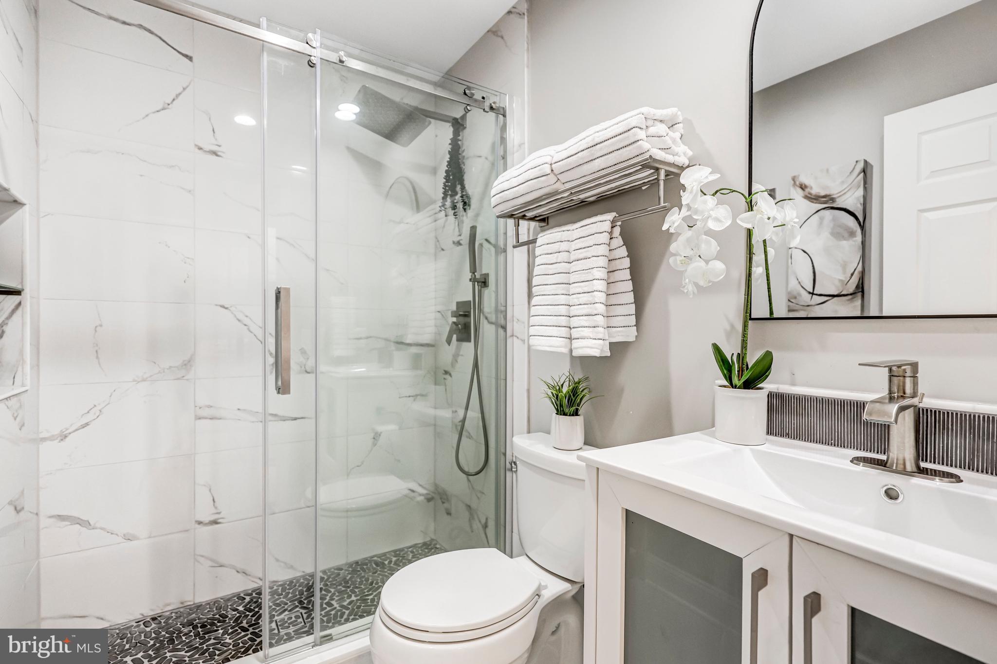 17 Alexander Street Alexandria, VA 22314 - Photo 23 of 30 a bathroom with a sink toilet and shower