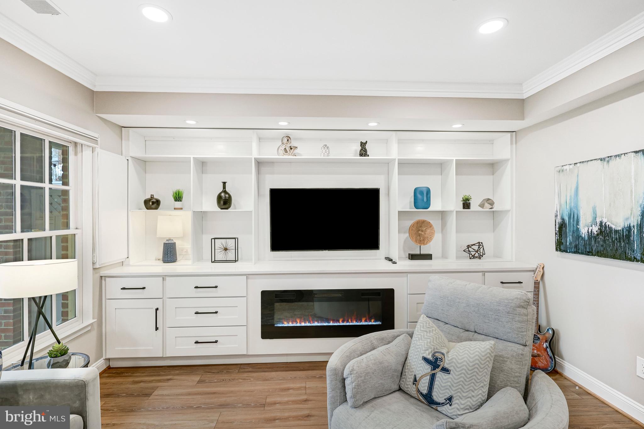 17 Alexander Street Alexandria, VA 22314 - Photo 27 of 30 a living room with furniture a fireplace and a flat screen tv