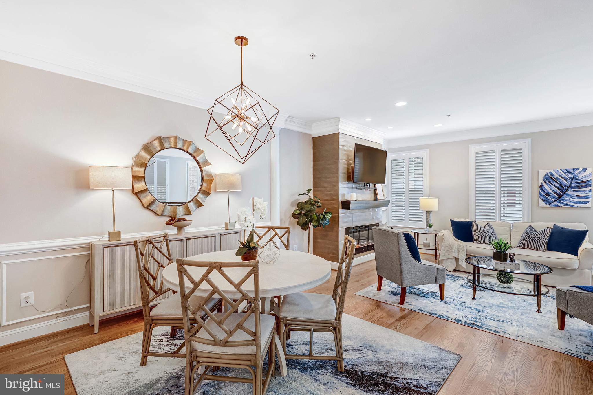 17 Alexander Street Alexandria, VA 22314 - Photo 7 of 30 a view of a dining room and livingroom with furniture wooden floor a rug and a chandelier