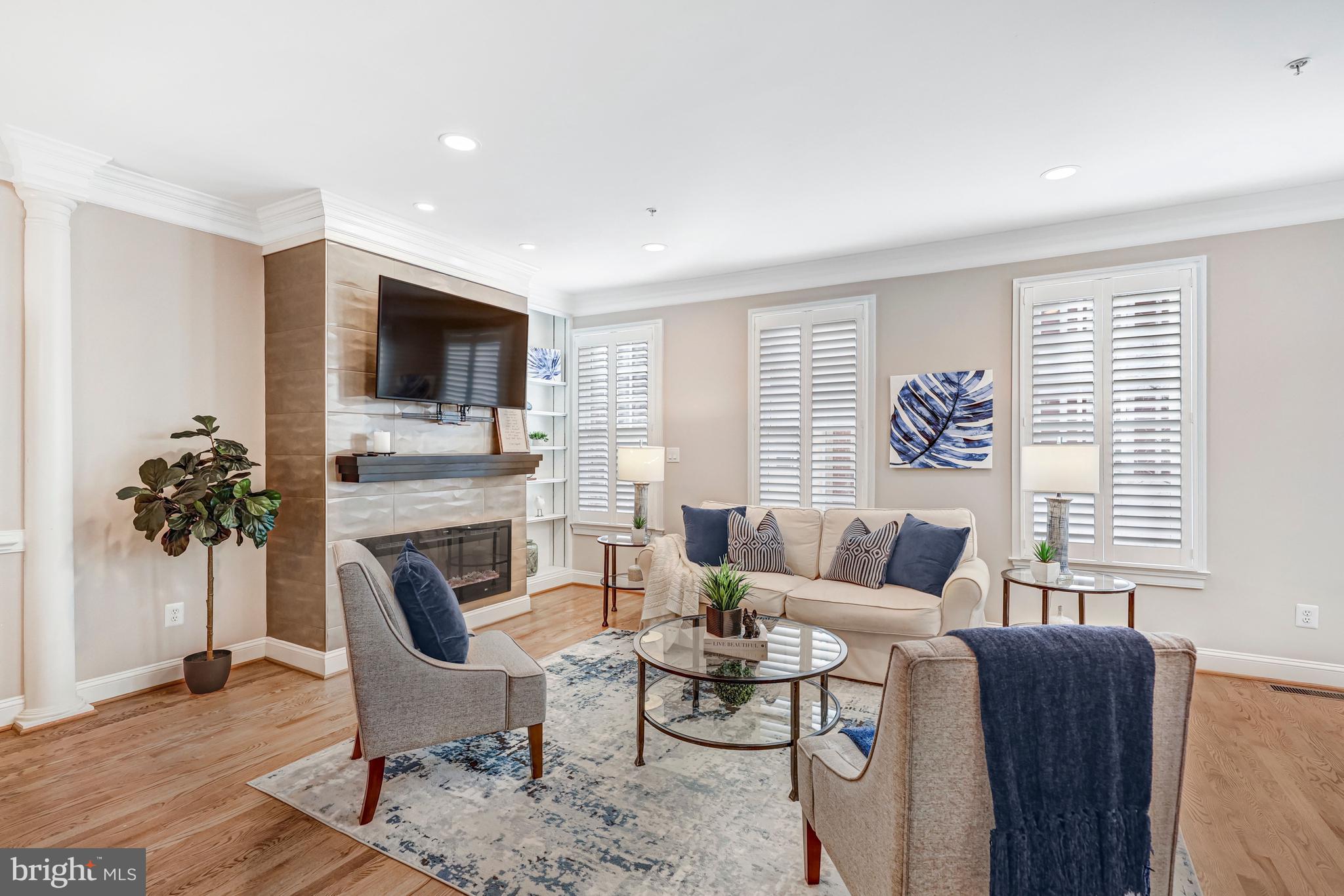 17 Alexander Street Alexandria, VA 22314 - Photo 8 of 30 a living room with furniture a fireplace and a flat screen tv