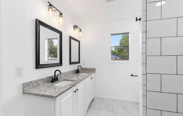 a bathroom with a sink and a mirror