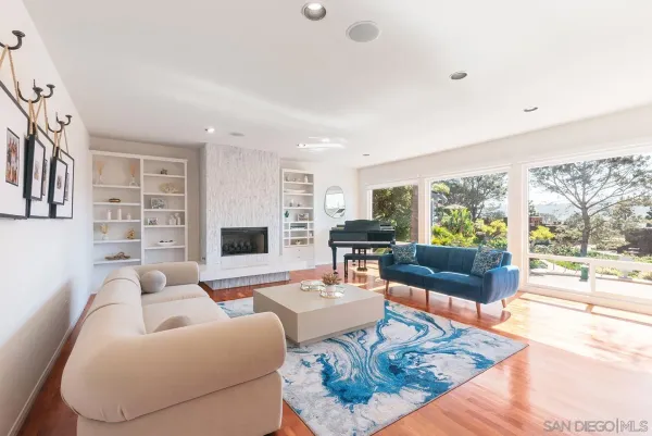 a living room with furniture a rug and a flat screen tv