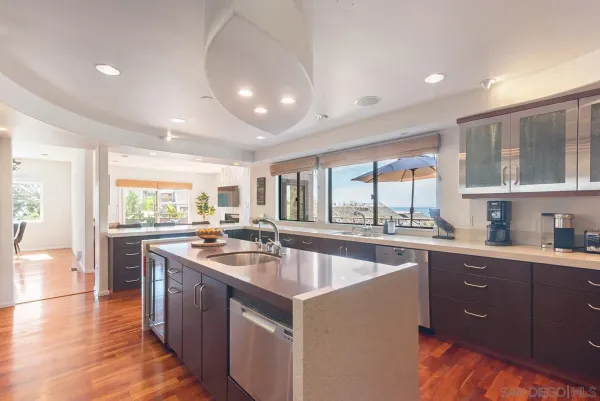 a kitchen with stainless steel appliances granite countertop a sink and cabinets